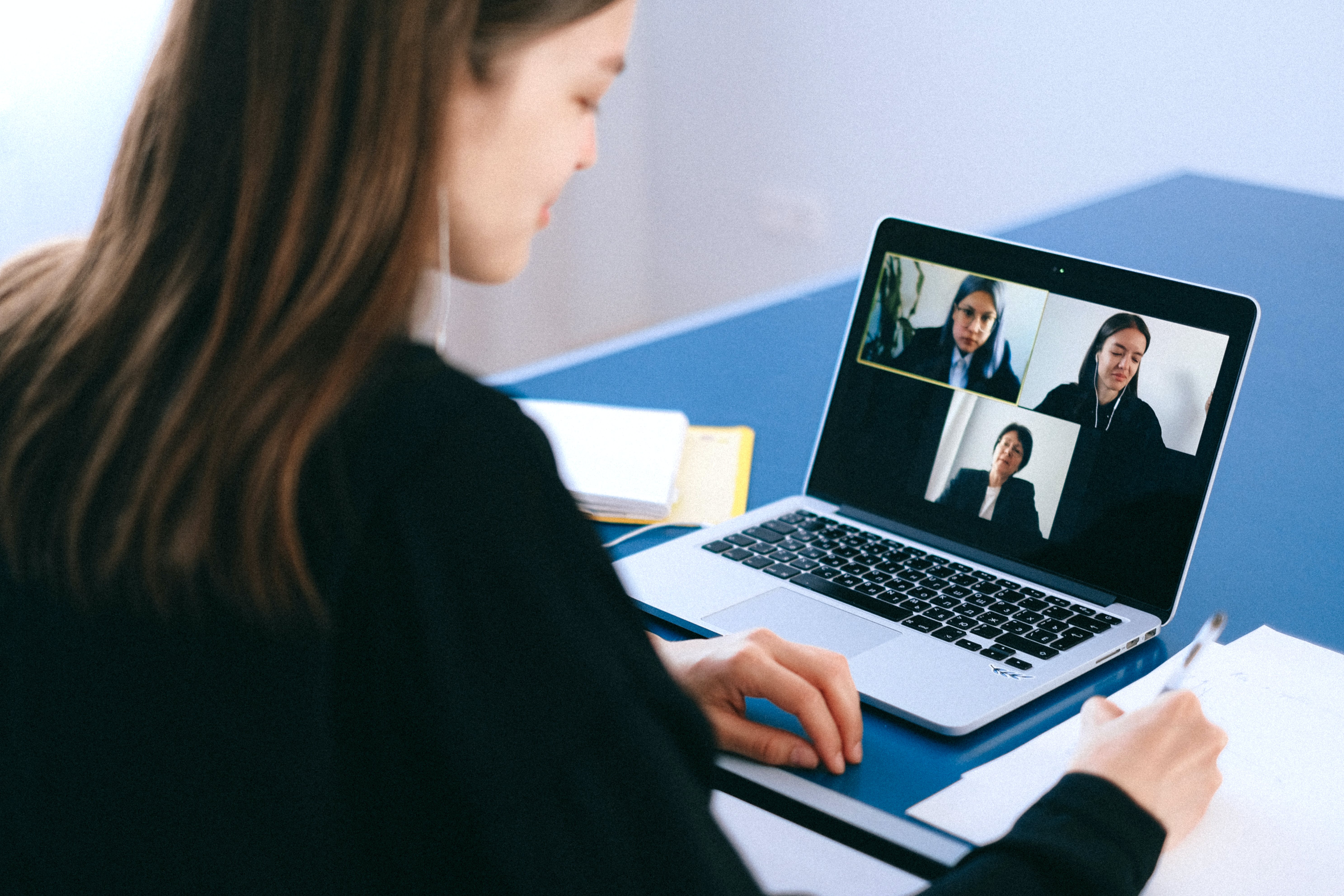 Woman in a meeting with 3 more people